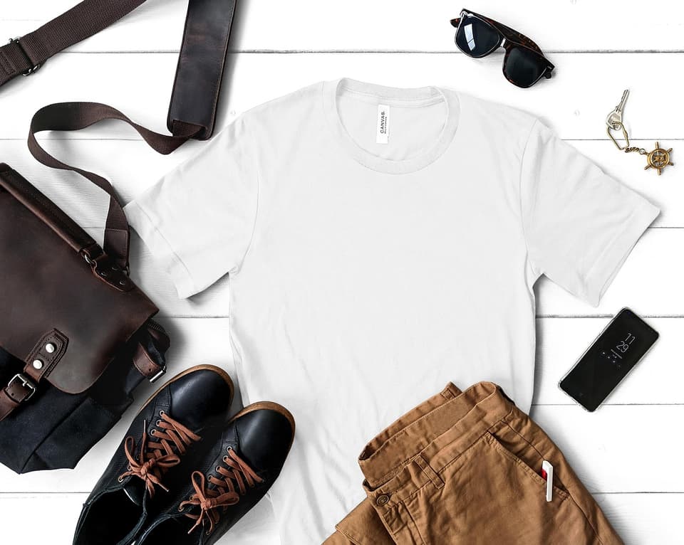 White crew tee styled with leather bag, boots, and sunglasses